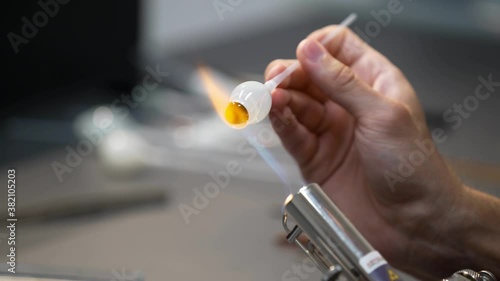 Glass eye prosthetic production (Ocular prosthesis). Burning Glass on a burner. 4K Video photo