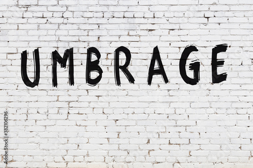 Inscription umbrage painted on white brick wall