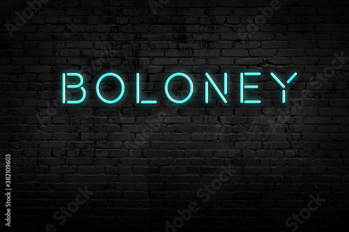 Night view of neon sign on brick wall with inscription boloney