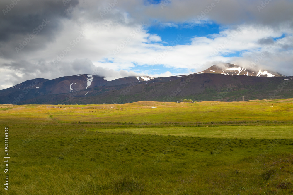 Graphic snow patches on the mountains. Summer nordic landscape. East Iceland.