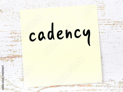 Canvas Print Yellow sticky note on wooden wall with handwritten word cadency