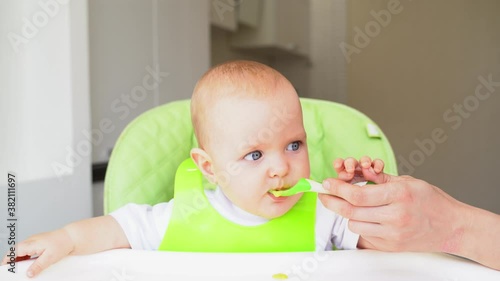 mom feeds the baby from a spoon the first lure