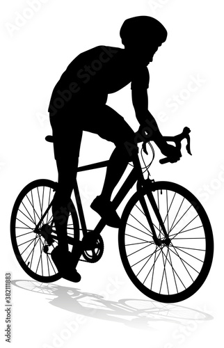 Bicyclist riding their bike and wearing a safety helmet in silhouette