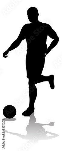 A soccer or football player in silhouette