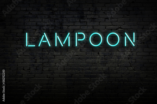 Foto Neon sign. Word lampoon against brick wall. Night view