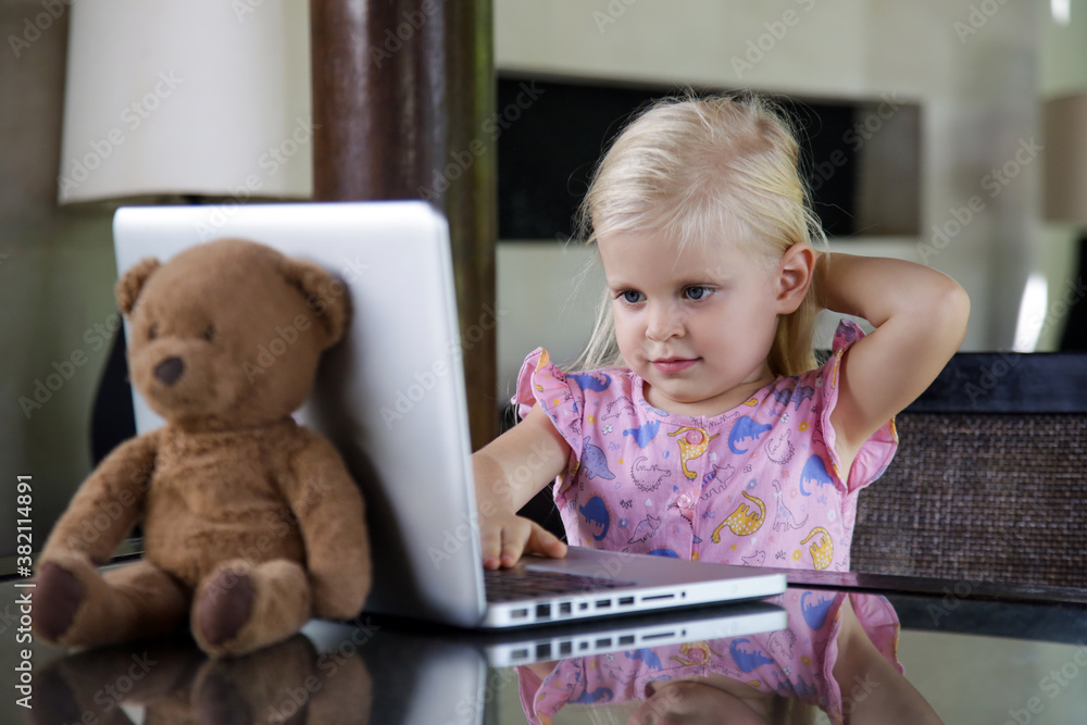 Happy 3 years old girl in front of laptop Happy 3 years old girl in front of laptop