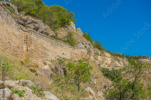 the remains of a medieval fortress city  according to other sources - a monastery  Tepe-Kermen  covering the upper part of the mountain in several tiers