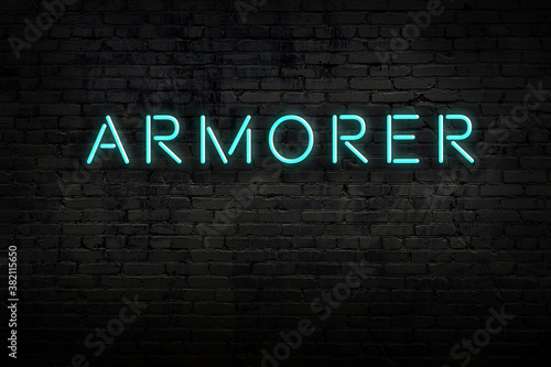 Neon sign. Word armorer against brick wall. Night view photo