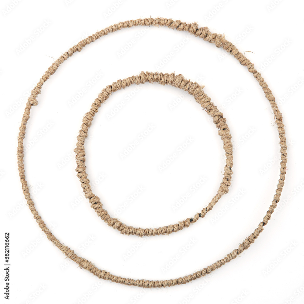 Two round frames made of linen rope string isolated on white background. Jute thread circles frames for diy craft. Two round frames made of linen rope string isolated on white background. Jute thread circles frames for diy craft.