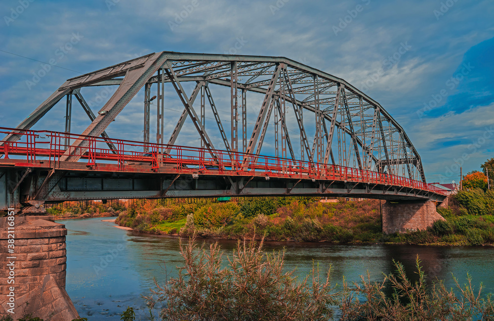 Metal construction of the city bridge on a sunny day in Kungur, Perm krai, Russia.