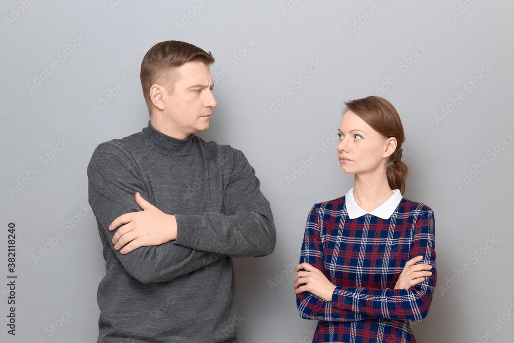 Portrait of serious man and woman looking at each other Portrait of serious man and woman looking at each other