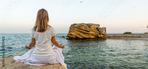 Woman meditating at the sea