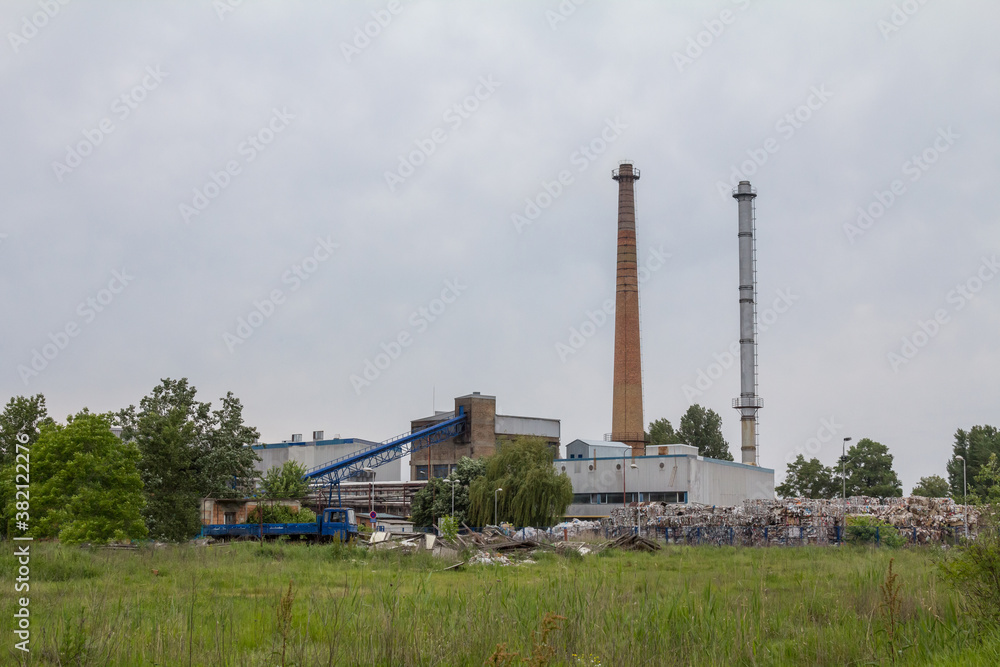 Panorama of a recycling paper factory processing plant with piles of cardboard waiting to be recycled in an industrial facility aimed at waste management