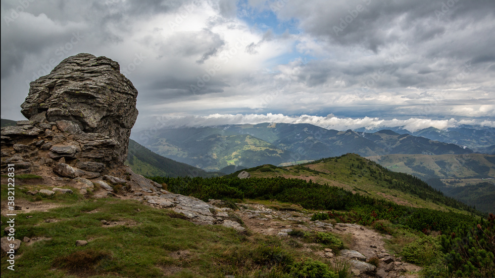 Obraz premium Beautiful gloomy mountain landscape after the rain. Rocks in the foreground and clouds in the background