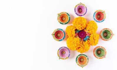 Happy Diwali - Clay Diya lamps lit during Dipavali, Hindu festival of lights celebration. Colorful traditional oil lamp diya on white background