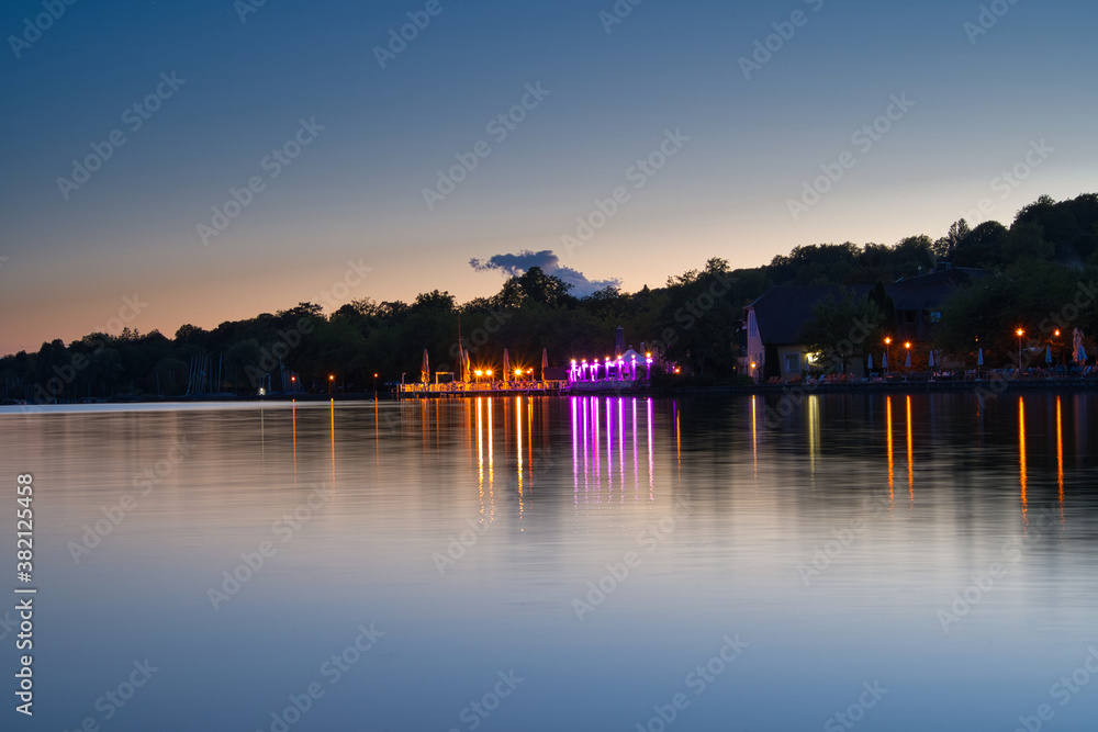 Obraz premium Lichter reflektieren auf dem Wasser, Starnberger See nach dem Sonnenuntergang