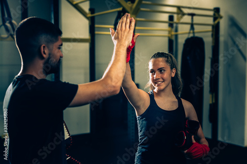 woman handshake with her personal trainer in gym