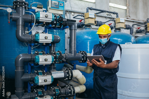 Fototapeta industry worker checking chemical water treatment equipment