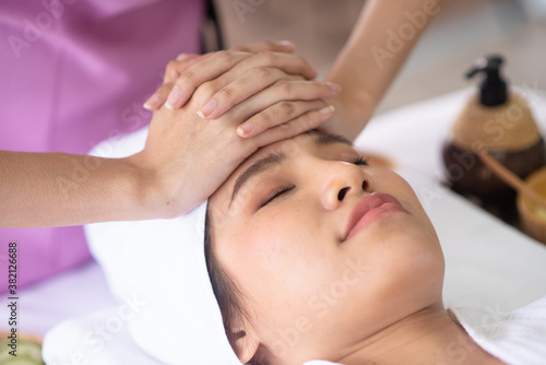 Therapist use her hand touch client forehead for treament