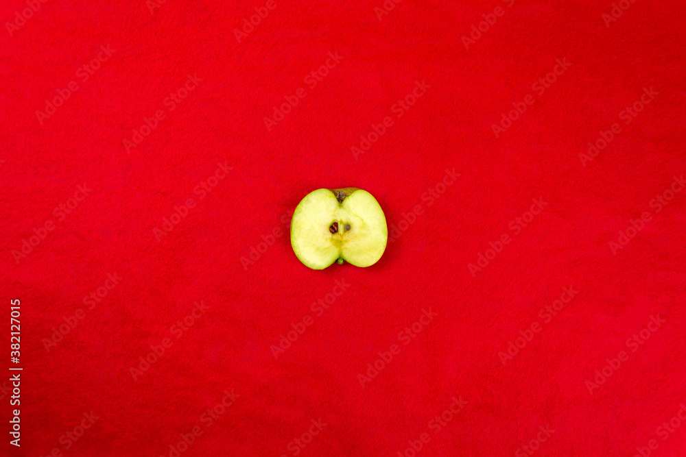 Green apples on a red background Green apples on a red background