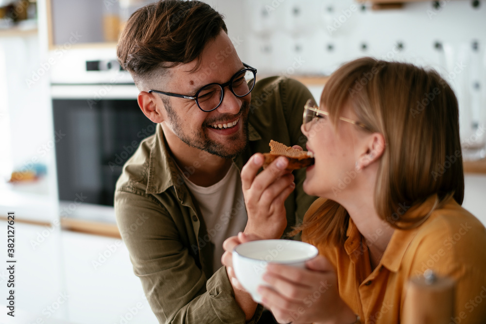 Young couple making delicious food at home. Loving couple enjoying in the kitchen.. Young couple making delicious food at home. Loving couple enjoying in the kitchen..