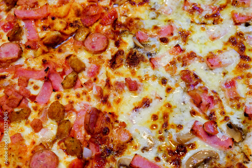 Closeup of Italian pizza. Tasty pepperoni pizza and cooking ingredients. Half pepperoni half mushroom