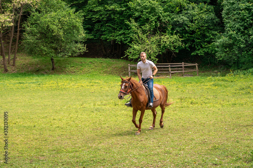 Young man enjoying horseback riding on a ranch