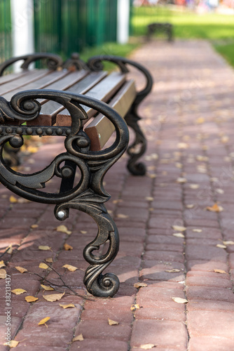 Bench for recreation in the autumn Park on the alley.