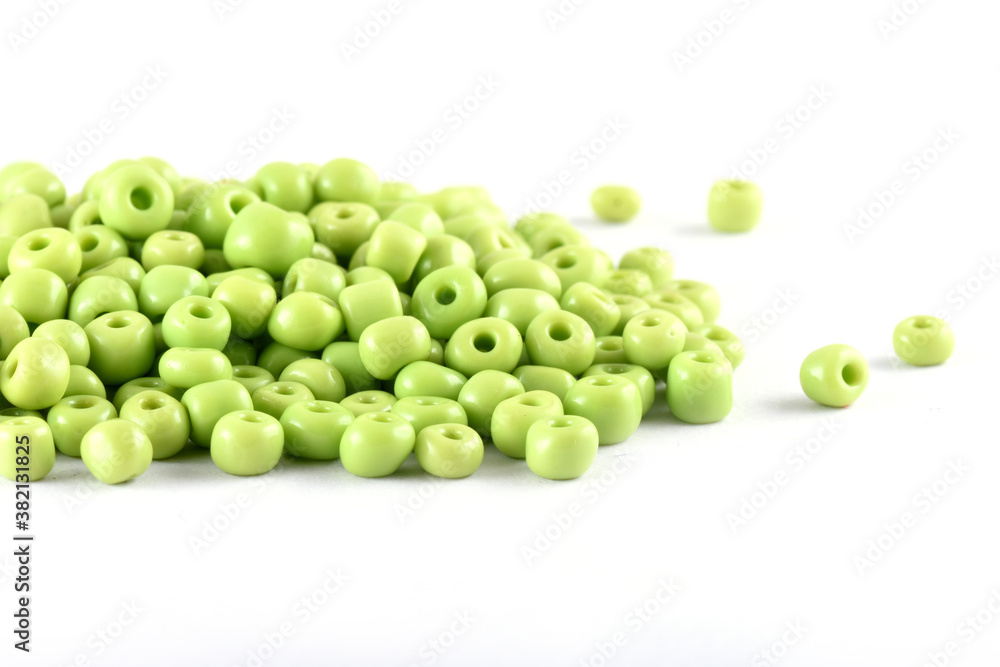 Close up of Light green Beads on the white background. Background or texture of beads. macro,It is used in finishing fashion clothes. make bead necklace or string of beads for woman of fashion. Close up of Light green Beads on the white background. Background or texture of beads. macro,It is used in finishing fashion clothes. make bead necklace or string of beads for woman of fashion.