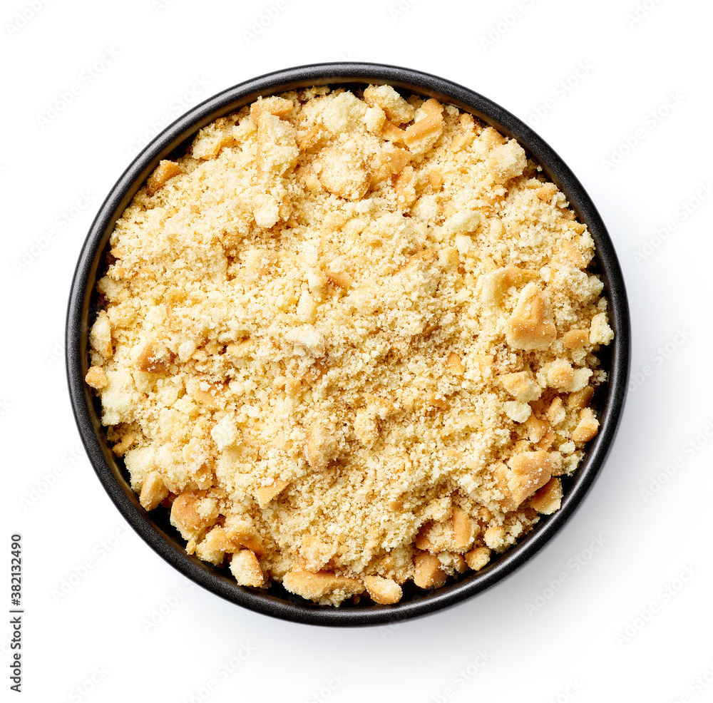 Bowl of biscuit crumbs isolated on white, from above Bowl of biscuit crumbs isolated on white, from above