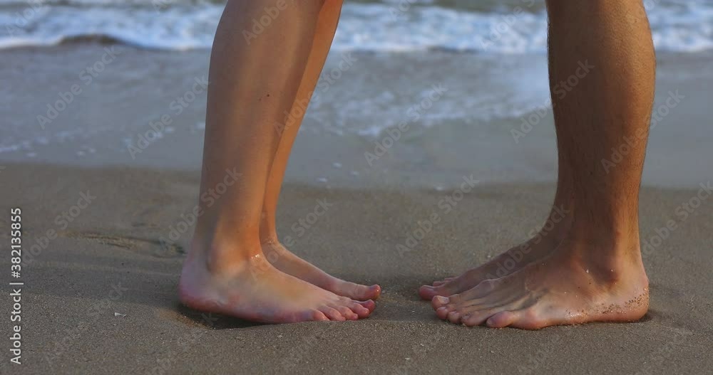 Couple foots kisses in sea waves. Love concept. Couple foots kisses in sea waves. Love concept.