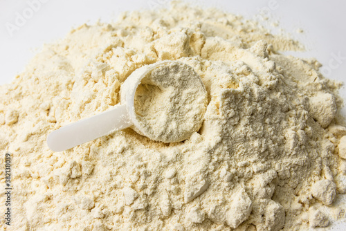 plastic scoop in whey protein heap