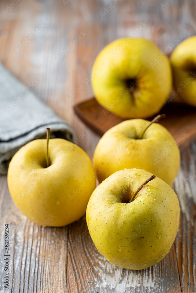 Granny smith organic apples close up on wooden rustic table for a grocery store catalogue Granny smith organic apples close up on wooden rustic table for a grocery store catalogue