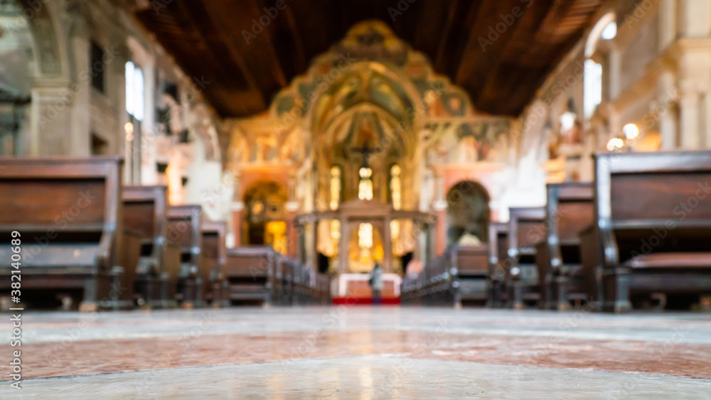 Blurred architecture background of church interior inside old cathedral catholic holy pray god jesus religion with candles 