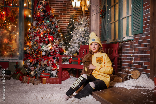 girl with christmas tree in the snow