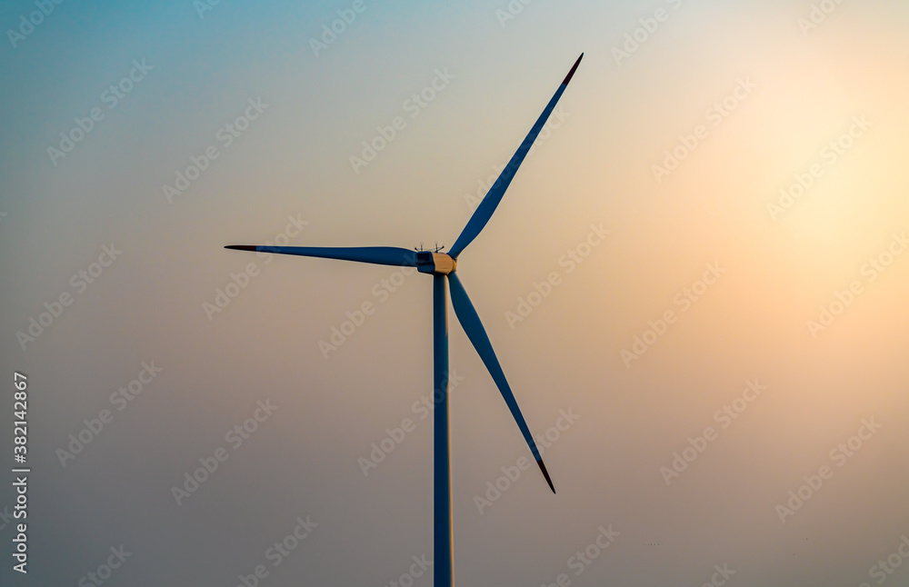 Wind turbine generating power in the evening.