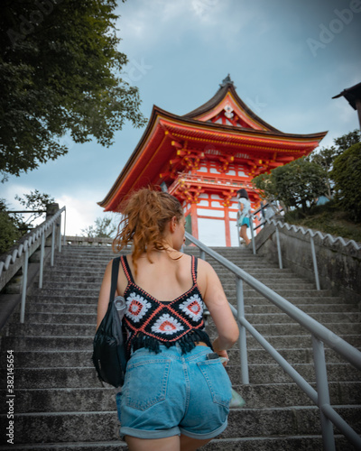 woman climbing temple stairs