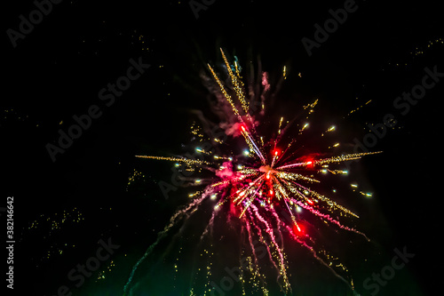 Glowing firecrackers in the sky at New Years Eve