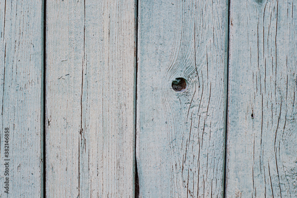 The texture of old, pale blue wood. The old boards were sun bleached and cracked. The texture of old, pale blue wood. The old boards were sun bleached and cracked.