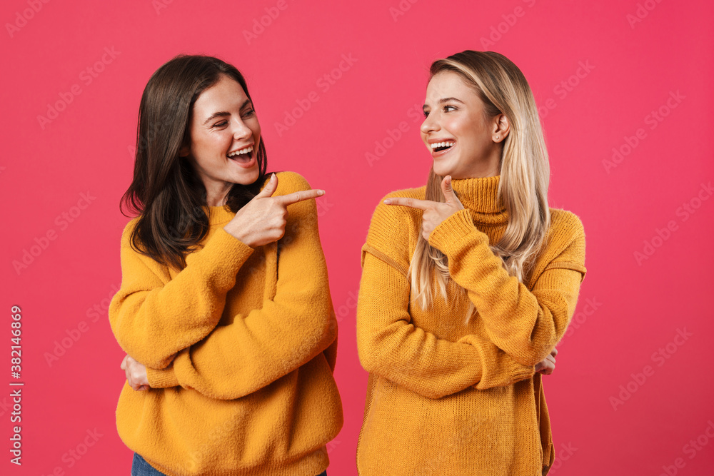 Image of funny beautiful women pointing fingers at each other Image of funny beautiful women pointing fingers at each other