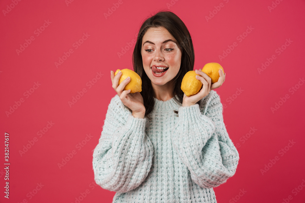 Image of happy beautiful girl posing with arms lemons Image of happy beautiful girl posing with arms lemons