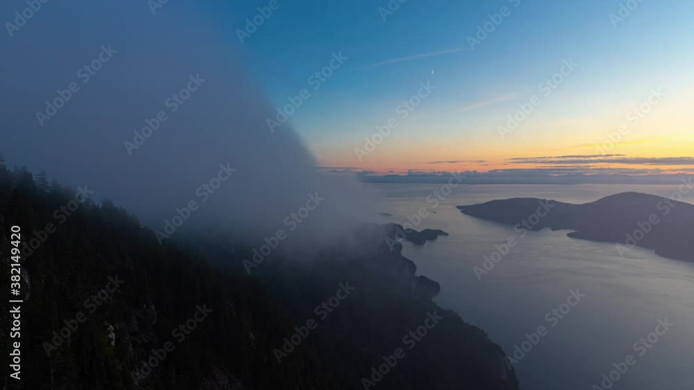 Timelapse. Beautiful View of Canadian Mountain Landscape during a colorful sunny sunset. Taken on St. Mark's Summit, West Vancouver, British Columbia, Canada. Nature Background. Pan Left Timelapse. Beautiful View of Canadian Mountain Landscape during a colorful sunny sunset. Taken on St. Mark's Summit, West Vancouver, British Columbia, Canada. Nature Background. Pan Left