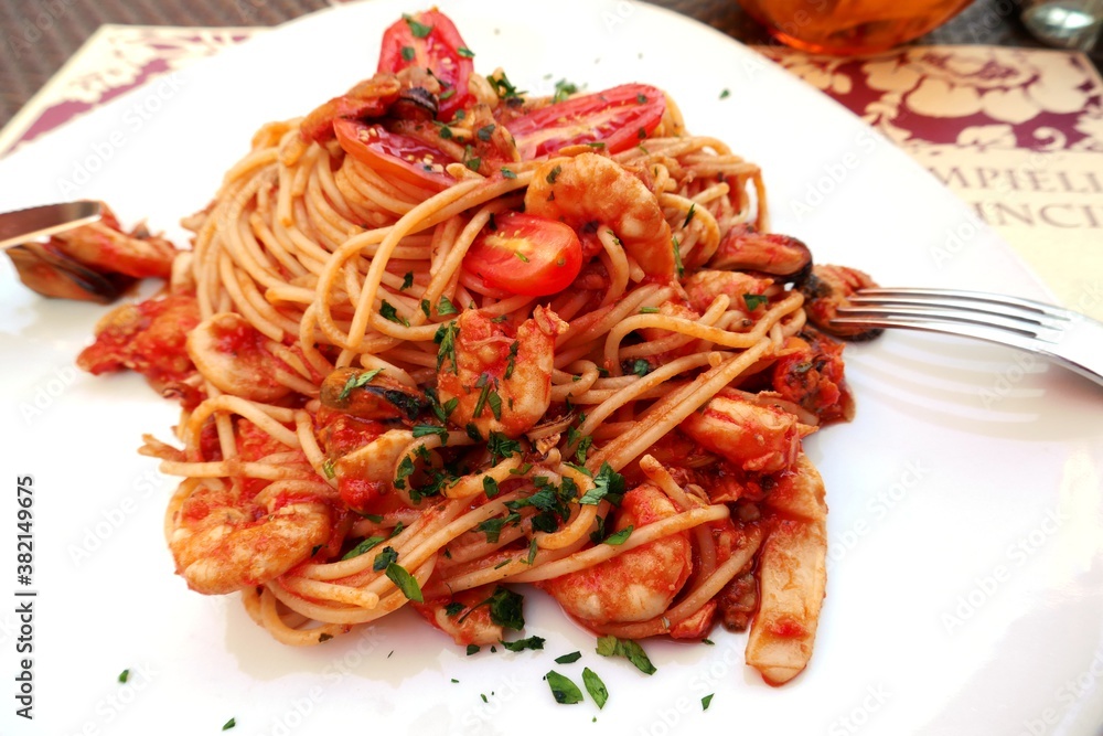 Italian pasta with seafood and tomatoes in restaurant Italian pasta with seafood and tomatoes in restaurant