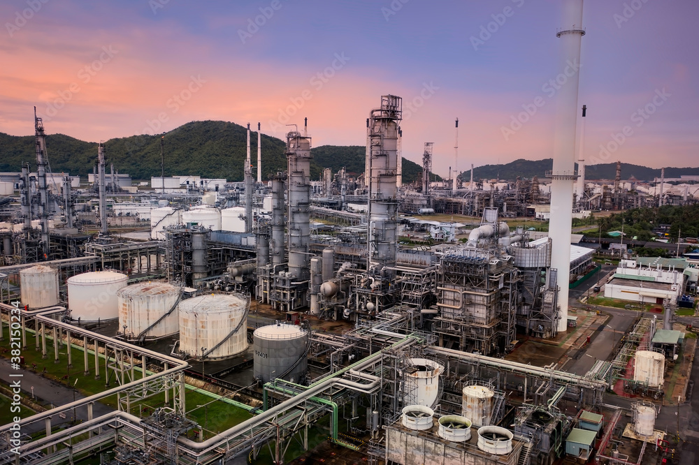 Aerial view of dusk sky scene with  Industrial view at oil refinery plant form industry zone ,which factory - petrochemical plant, Shot from drone of Oil refinery.