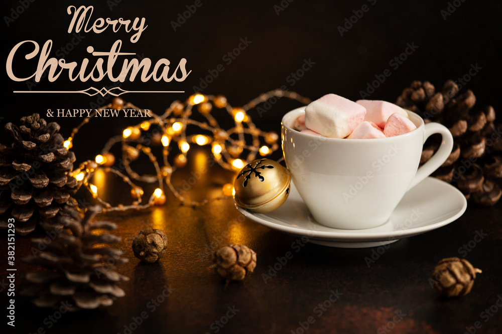 Fototapeta premium Warm cocoa drink with marshmallows. Christmas and New Year drink. Winter holidays concept with text - Merry Christmas and Happy New Year. Dark background