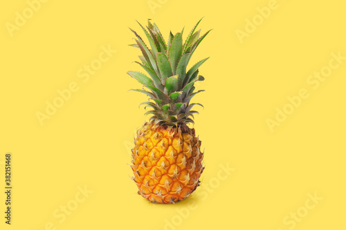 Isolated pineapple on a yellow background. Exotic fruits