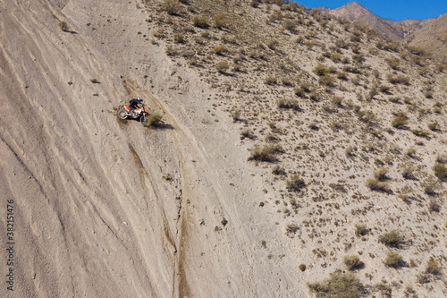 Extreme Rider climbing sand mountain on off-road cross enduro motorcycle