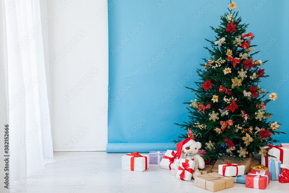 Obraz premium Christmas tree pine with gifts for the new year interior postcard banner background
