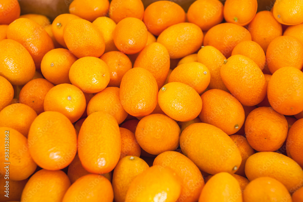 Fresh kumquat at the vegetable market, top view. Healthy food concept.
