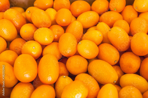 Fresh kumquat at the vegetable market  top view. Healthy food concept.